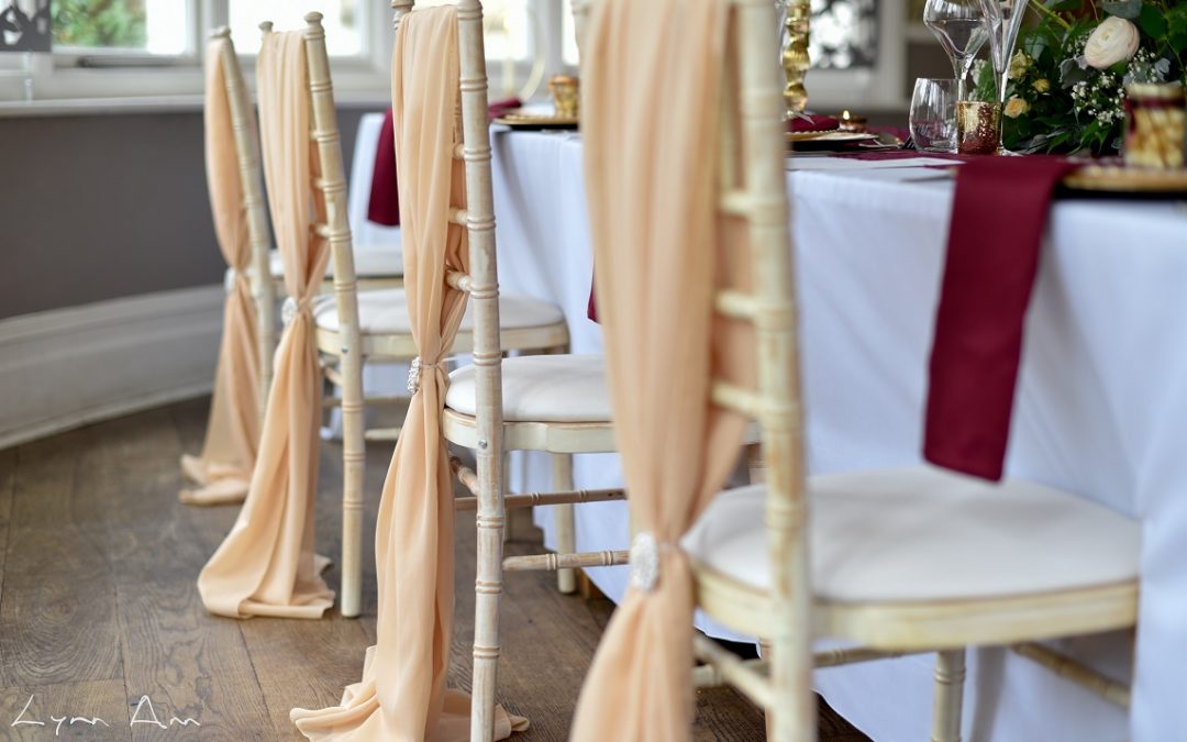 Limewashed chiavari chairs with ivory seat pads